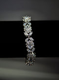 Bold crystal bangle featuring structured row of brilliant stones for polished statement sparkle, product view at Rebecca’s…