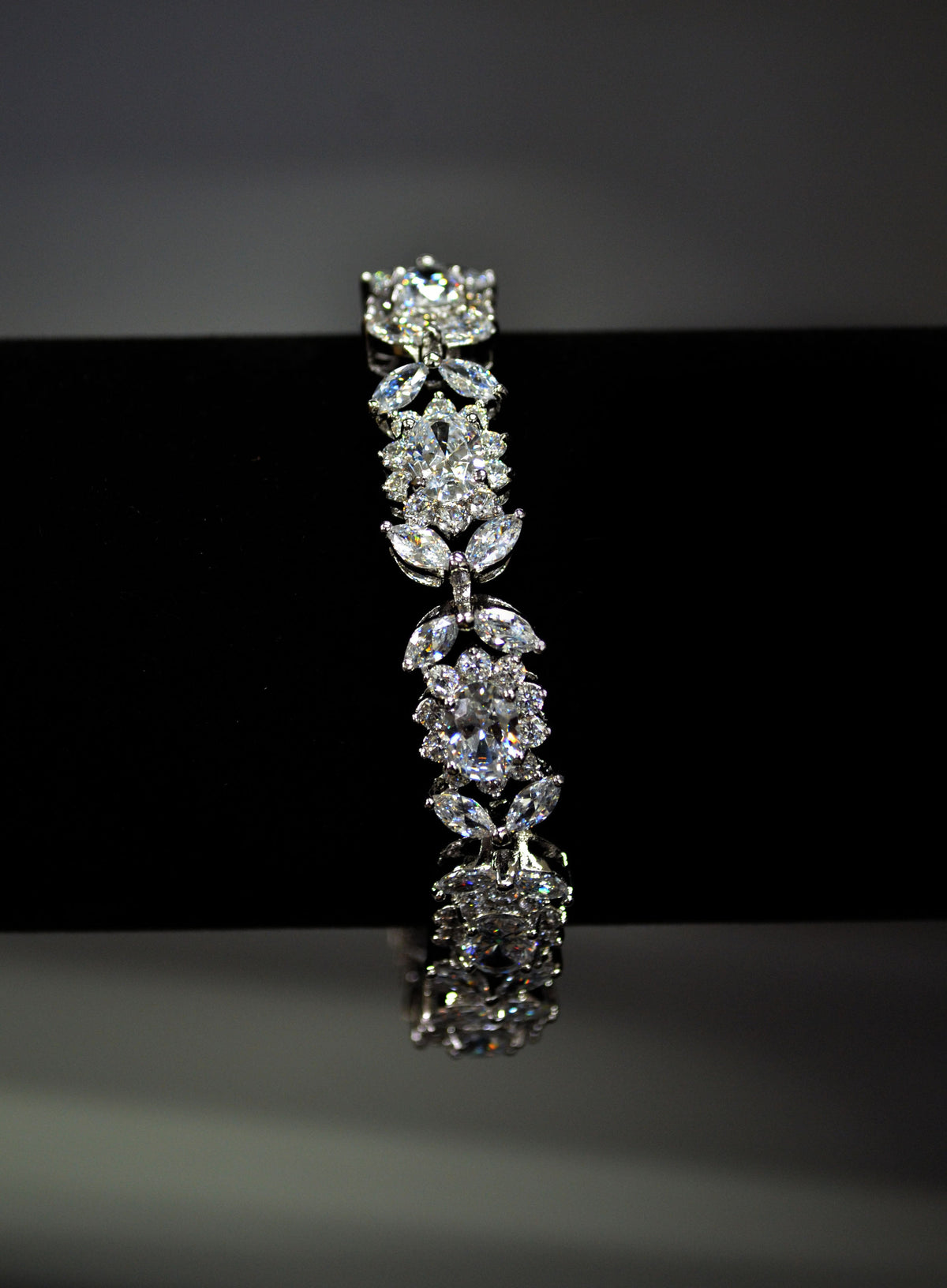 Bold crystal bangle featuring structured row of brilliant stones for polished statement sparkle, product view at Rebecca’s…