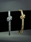 Crystal knot bangle featuring polished geometric knot with a fine double-row band, product view at Rebecca’s Louisville