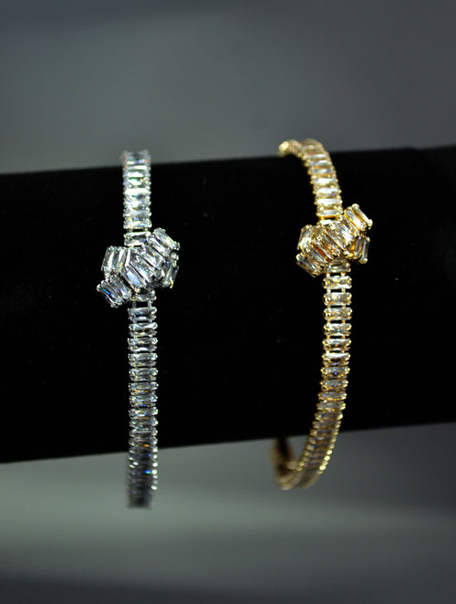 Crystal knot bangle featuring polished geometric knot with a fine double-row band, product view at Rebecca’s Louisville