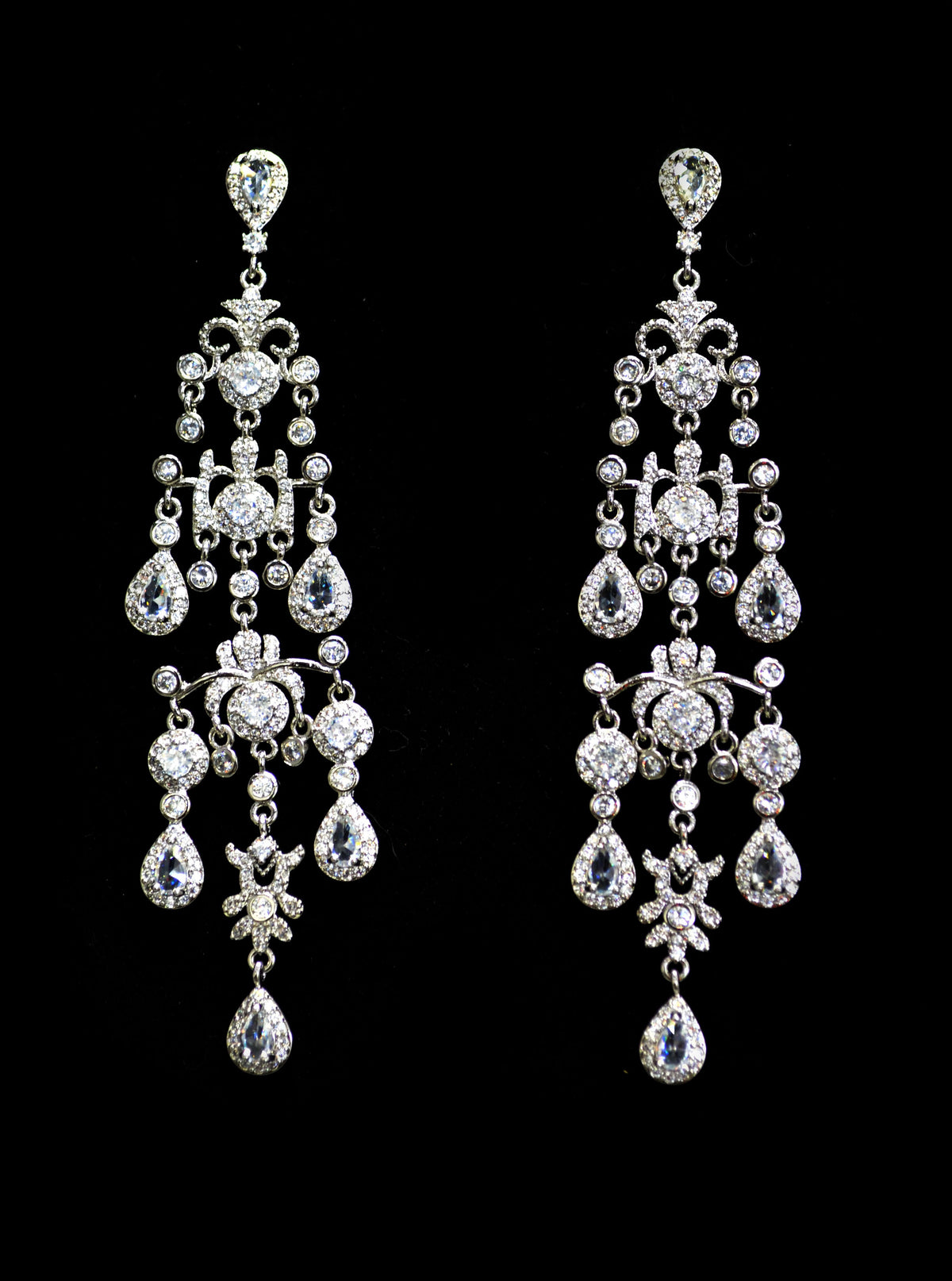 Crystal fringe chandelier earrings featuring multiple sparkling strands with petite teardrop ends, product view at…