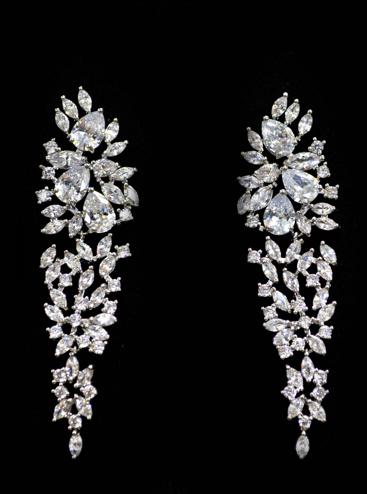Crystal leaf statement earrings featuring dramatic tapered cascade of marquise-cut stones, product view at Rebecca’s…