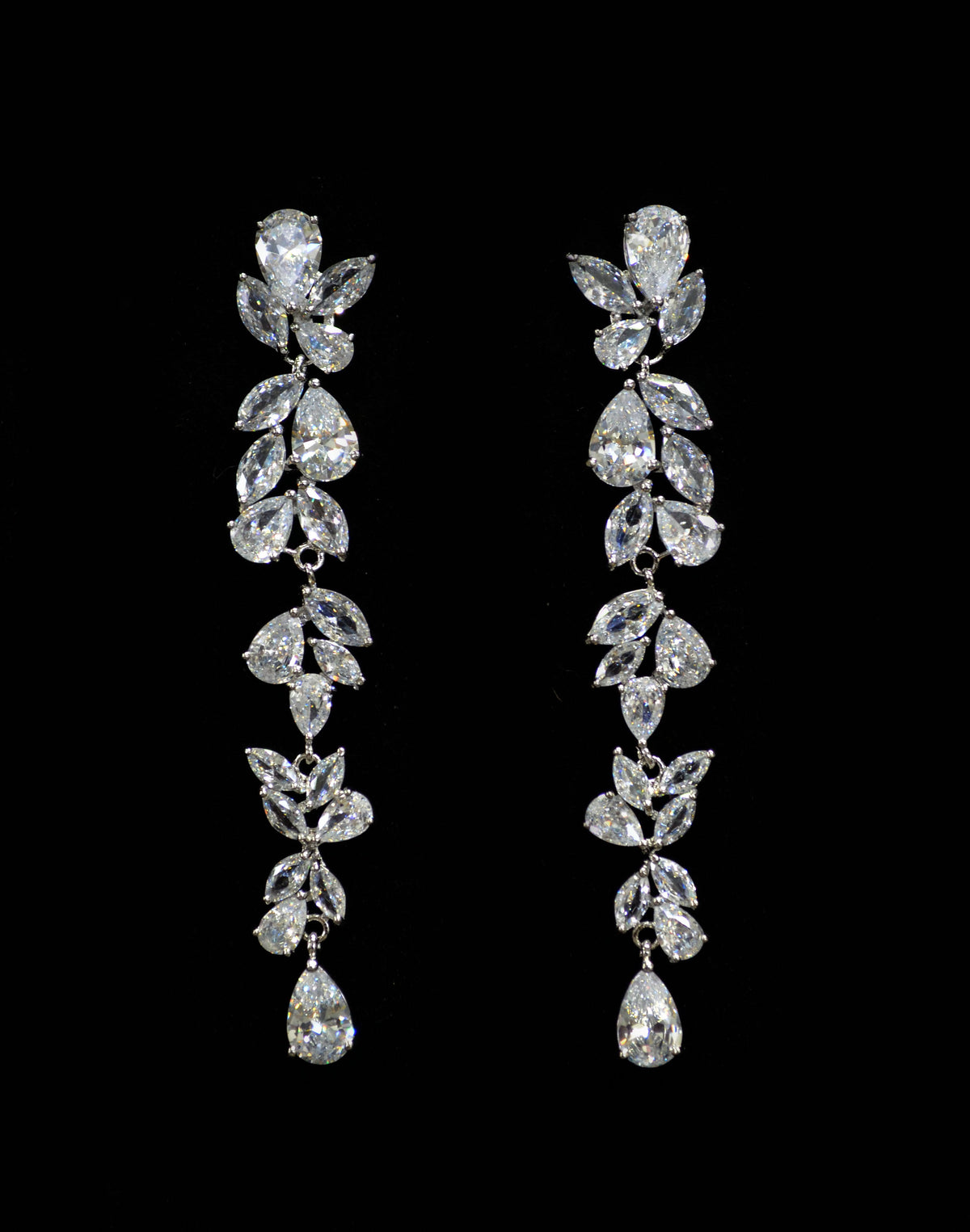 Botanical marquise crystal earrings featuring long branch of leaf-like stones finished with a petite teardrop, product view…