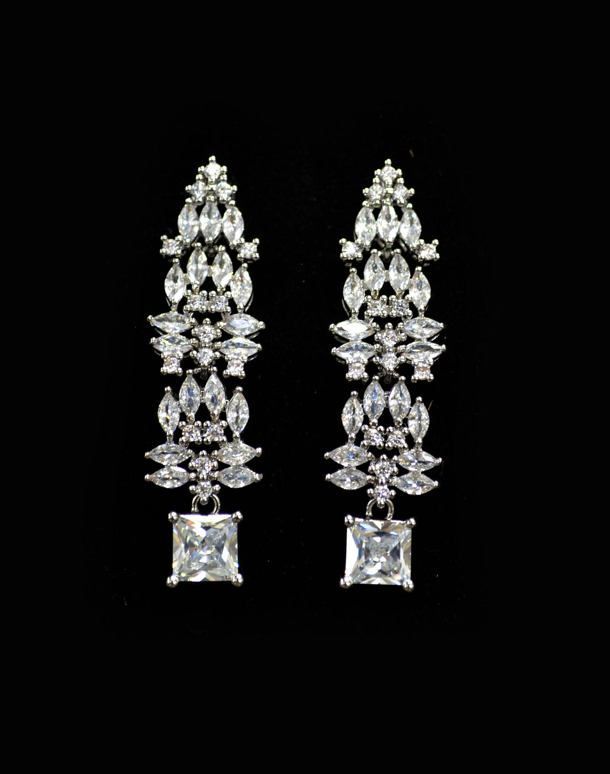Square and marquise crystal earrings featuring structured cascade ending in a brilliant square-cut stone, product view at…