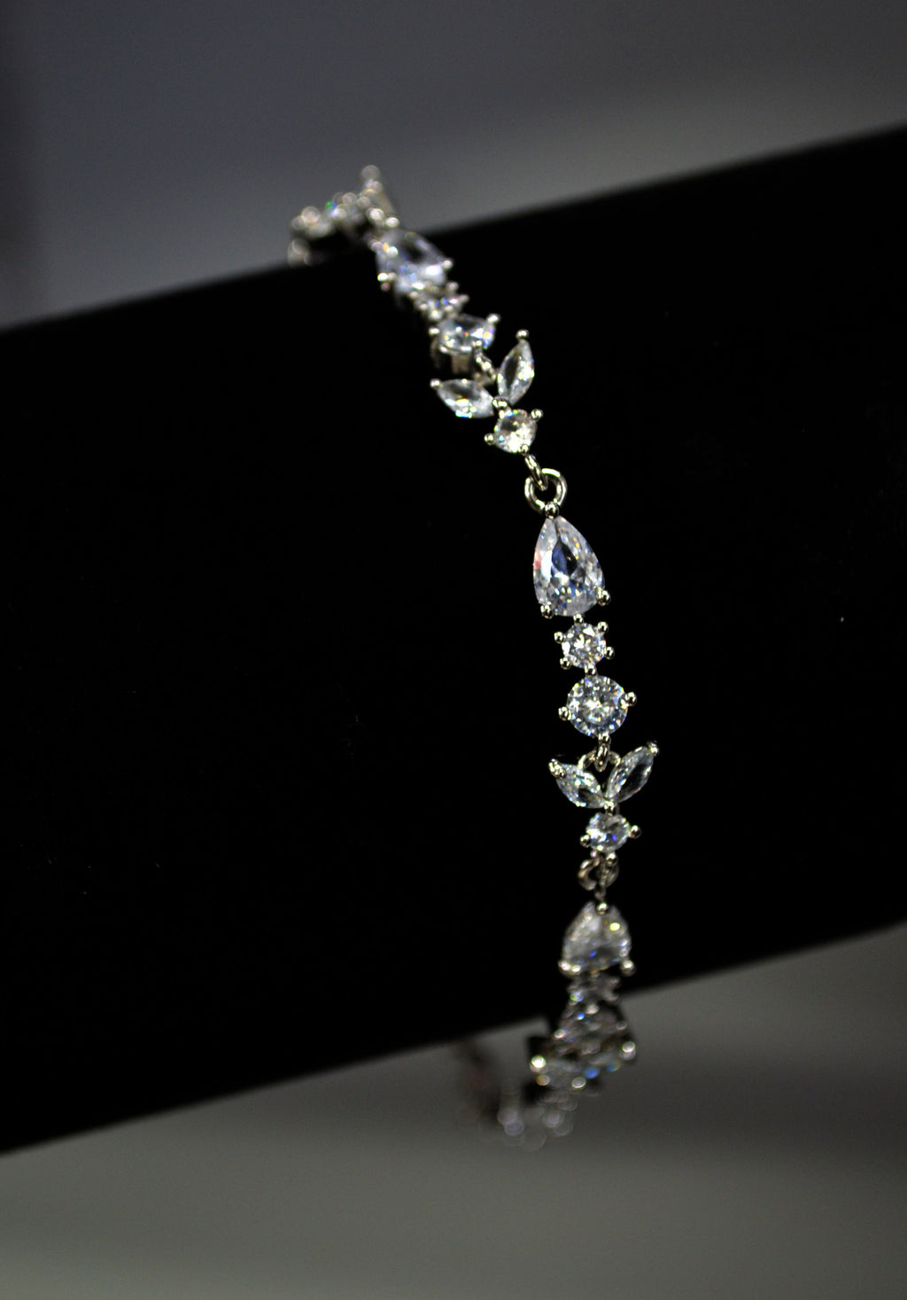 Three-piece teardrop crystal set featuring necklace, earrings, and bracelet with brilliant teardrop centers, alternate view…