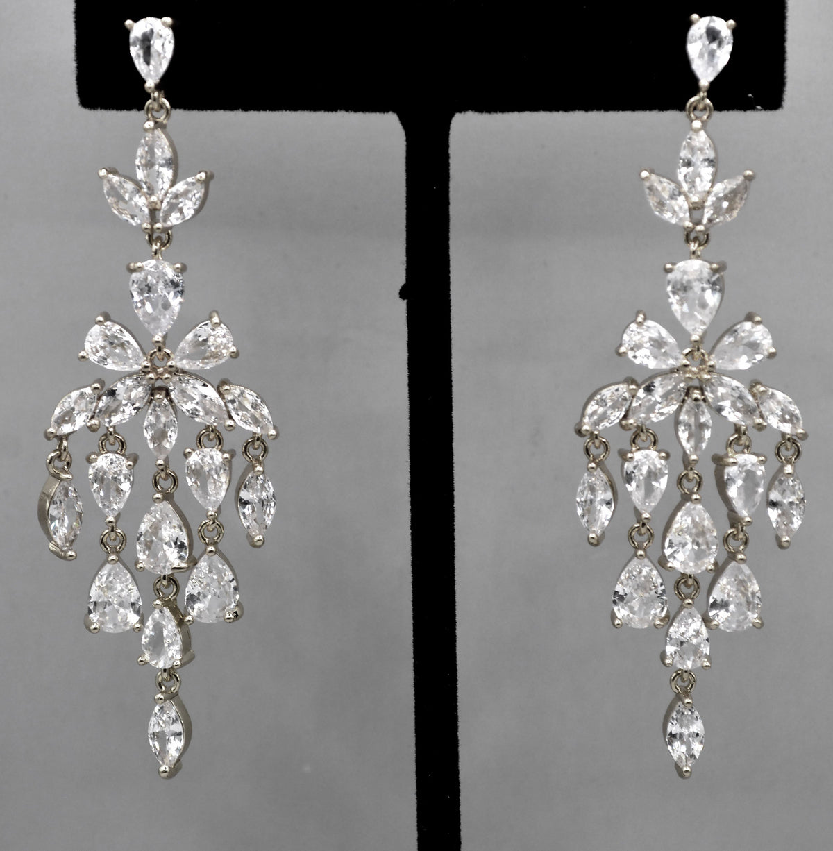 Marquise crystal chandelier earrings featuring layered leaf-shaped stones in a luminous statement drop, product view at…