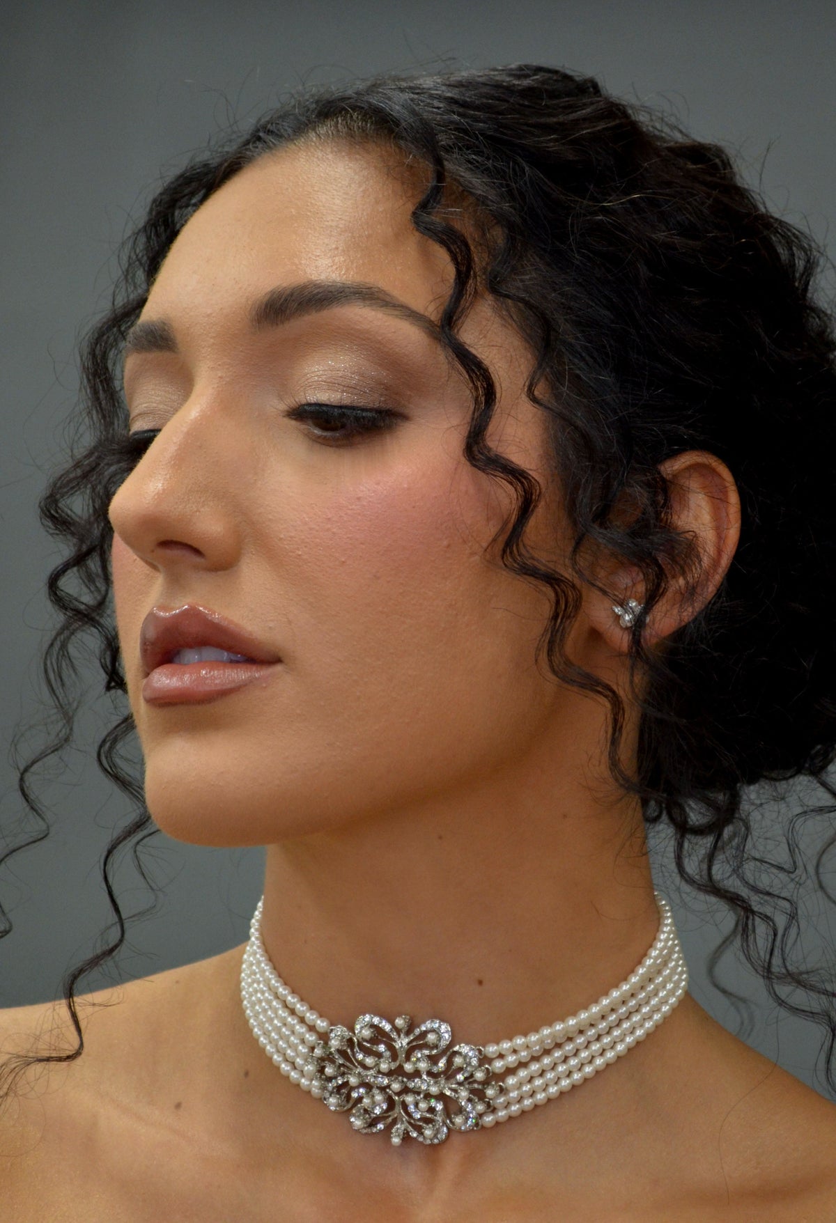 Wide crystal bridal choker featuring close-fitting band with a dimensional center medallion, product view at Rebecca’s…