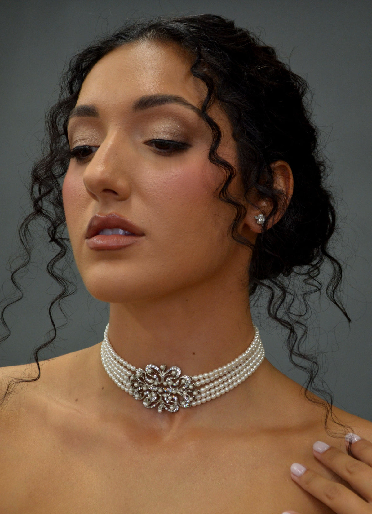 Wide crystal bridal choker featuring close-fitting band with a dimensional center medallion, detail view at Rebecca’s…