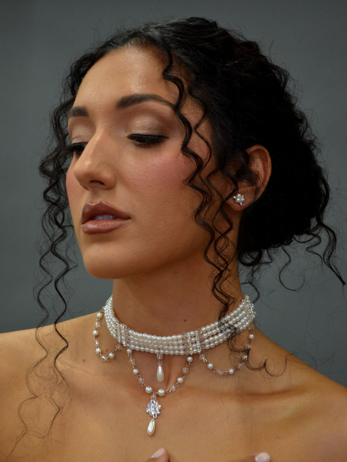 Pearl and crystal choker featuring slim pearl band with graduated crystal-and-pearl drops, product view at Rebecca’s…