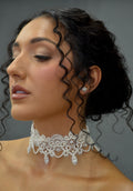 Lace-inspired pearl and crystal choker featuring ornate floral lace motif with pearl details and matching earrings, product…