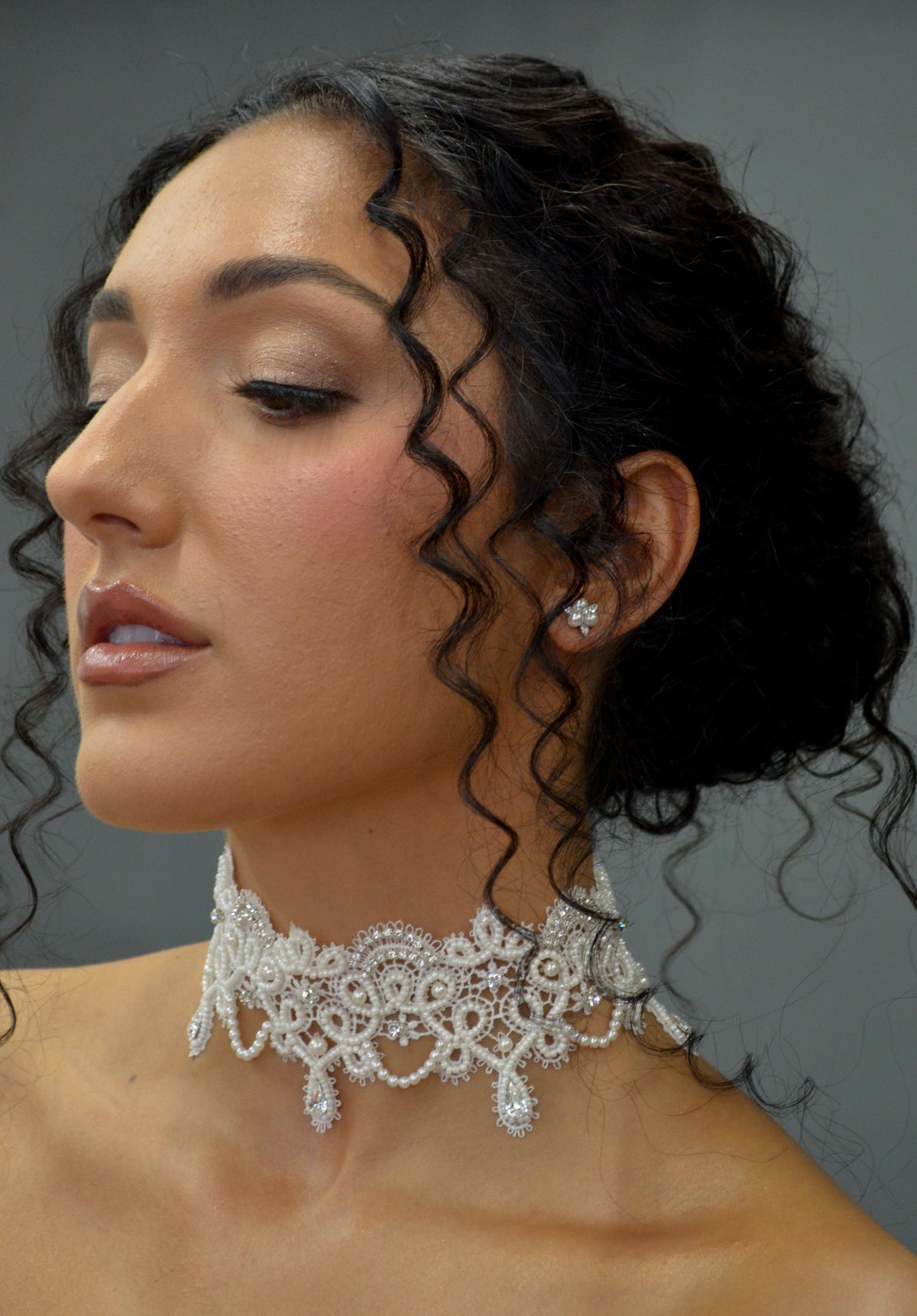 Lace-inspired pearl and crystal choker featuring ornate floral lace motif with pearl details and matching earrings, product…