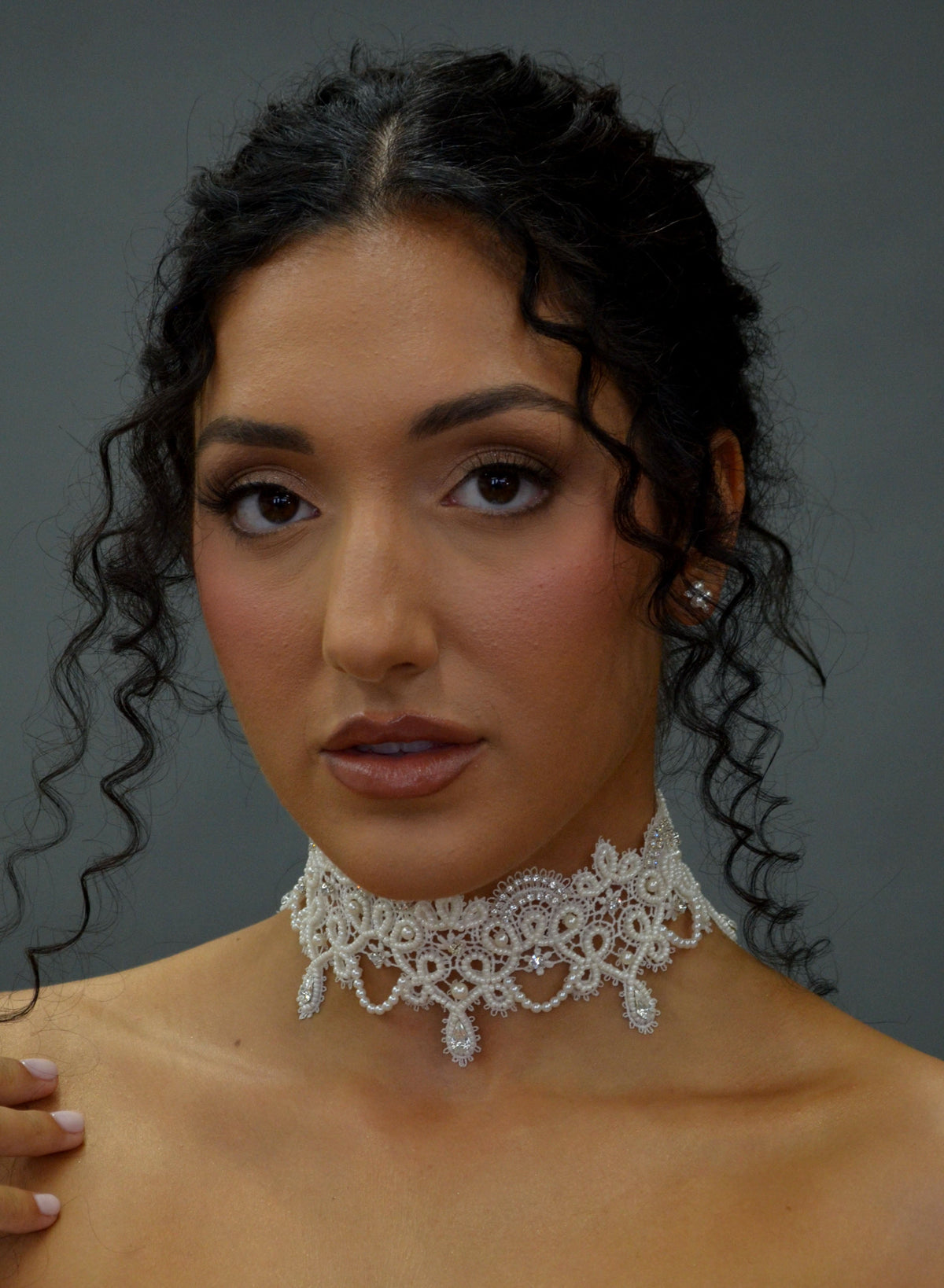 Lace-inspired pearl and crystal choker featuring ornate floral lace motif with pearl details and matching earrings,…