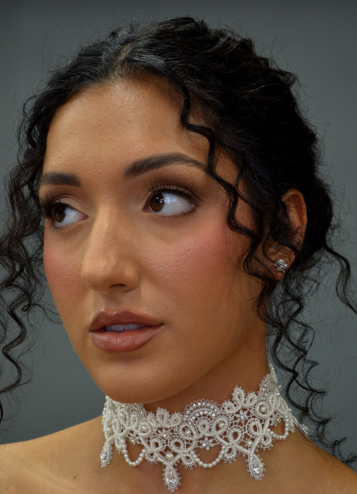 Lace-inspired pearl and crystal choker featuring ornate floral lace motif with pearl details and matching earrings, detail…