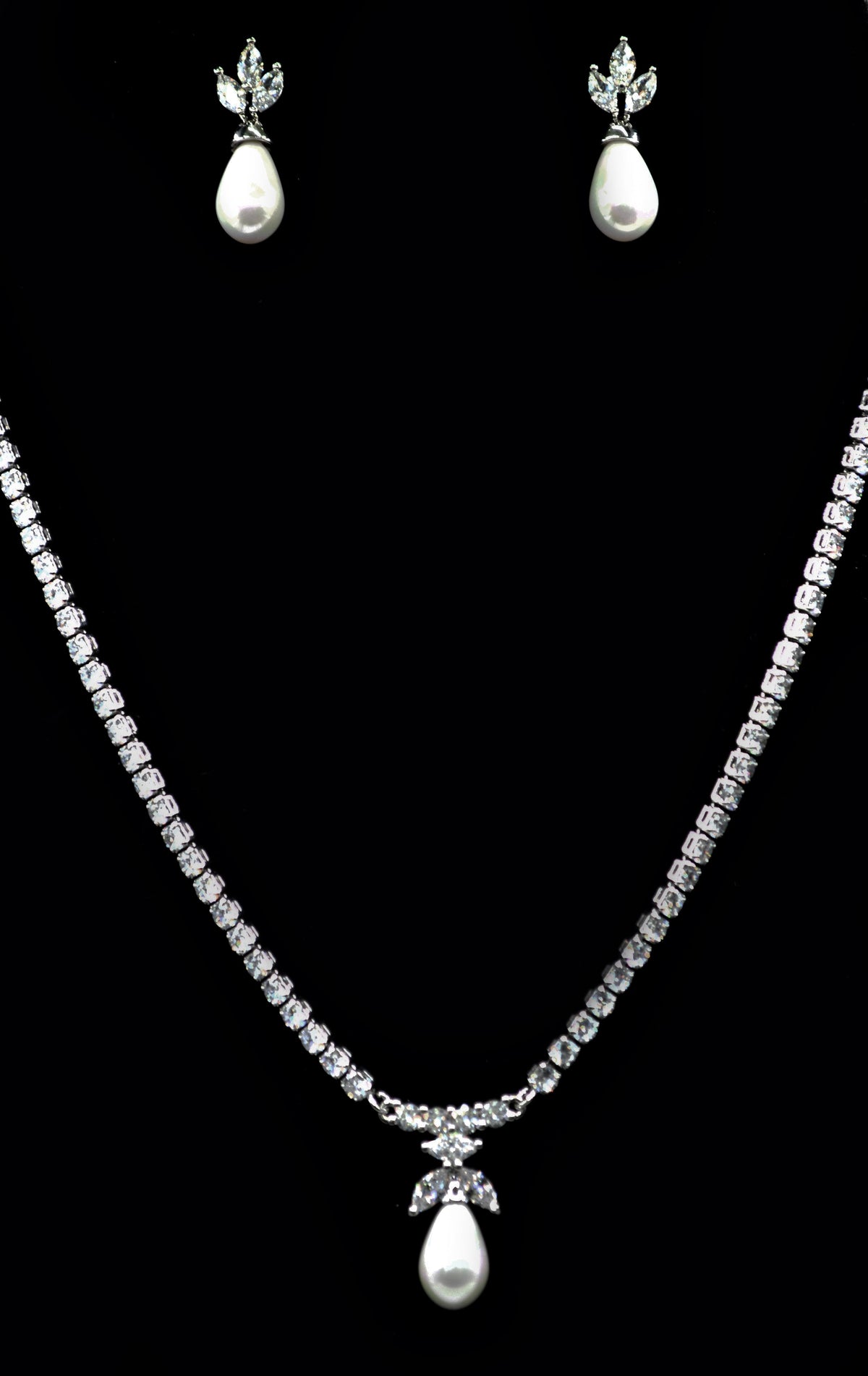 Crystal and pearl necklace-and-earring set featuring graduated crystal strand finished with matching pearl drops, product…