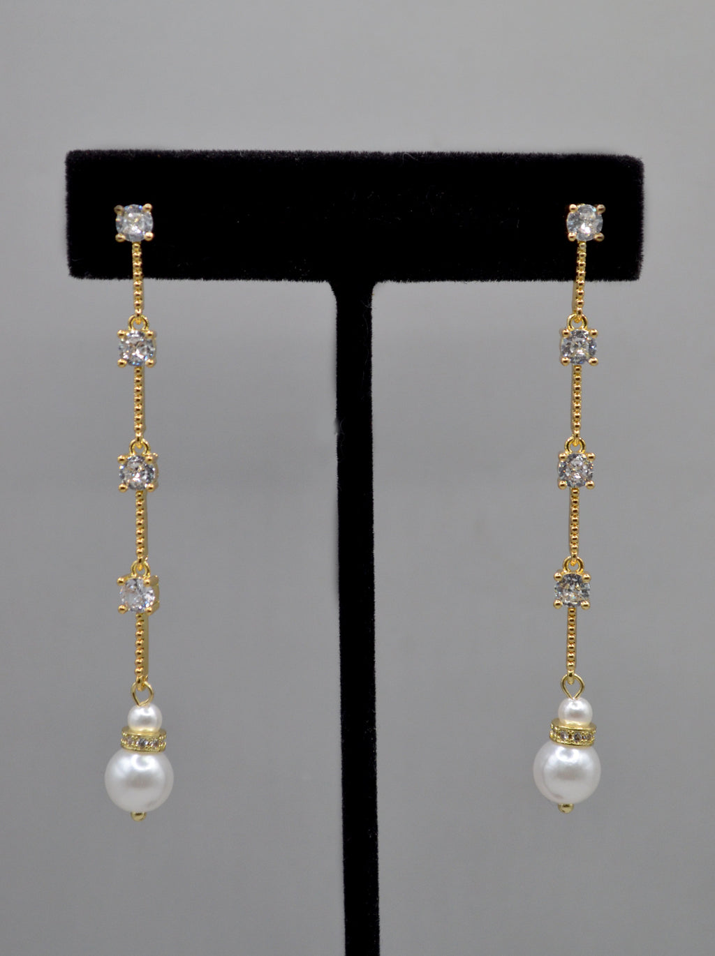 Long pearl and crystal earrings featuring fine linear drop finished with a petite pearl, product view at Rebecca’s Louisville