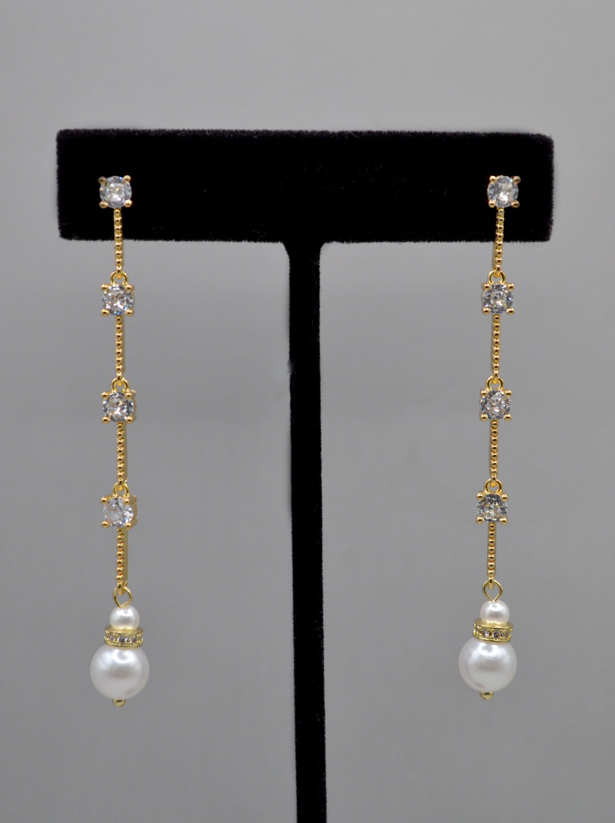 Long pearl and crystal earrings featuring fine linear drop finished with a petite pearl, product view at Rebecca’s Louisville