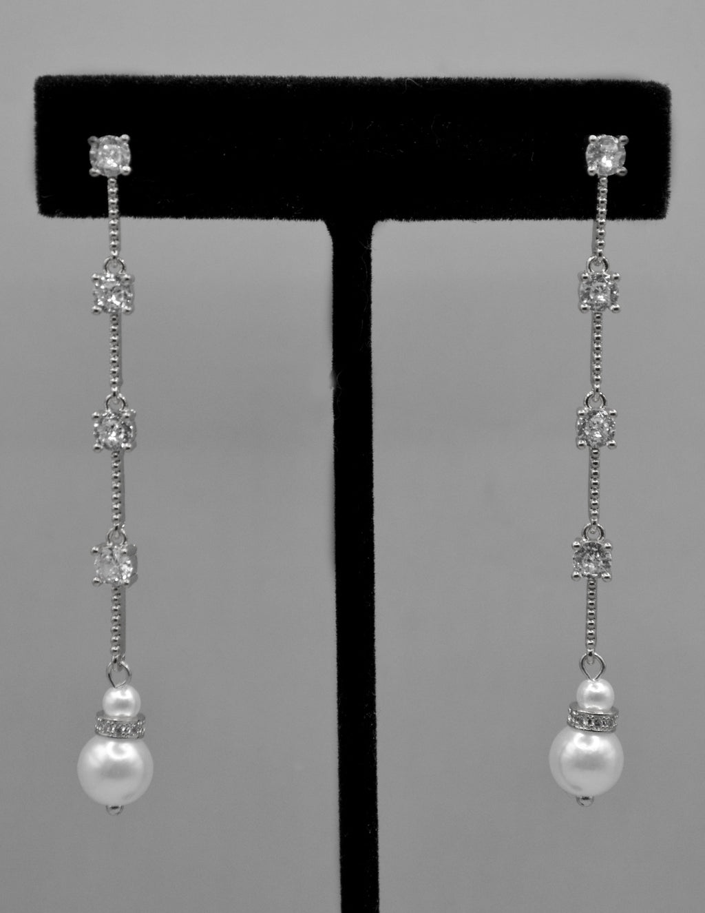 Long pearl and crystal earrings featuring fine linear drop finished with a petite pearl, detail view at Rebecca’s Louisville