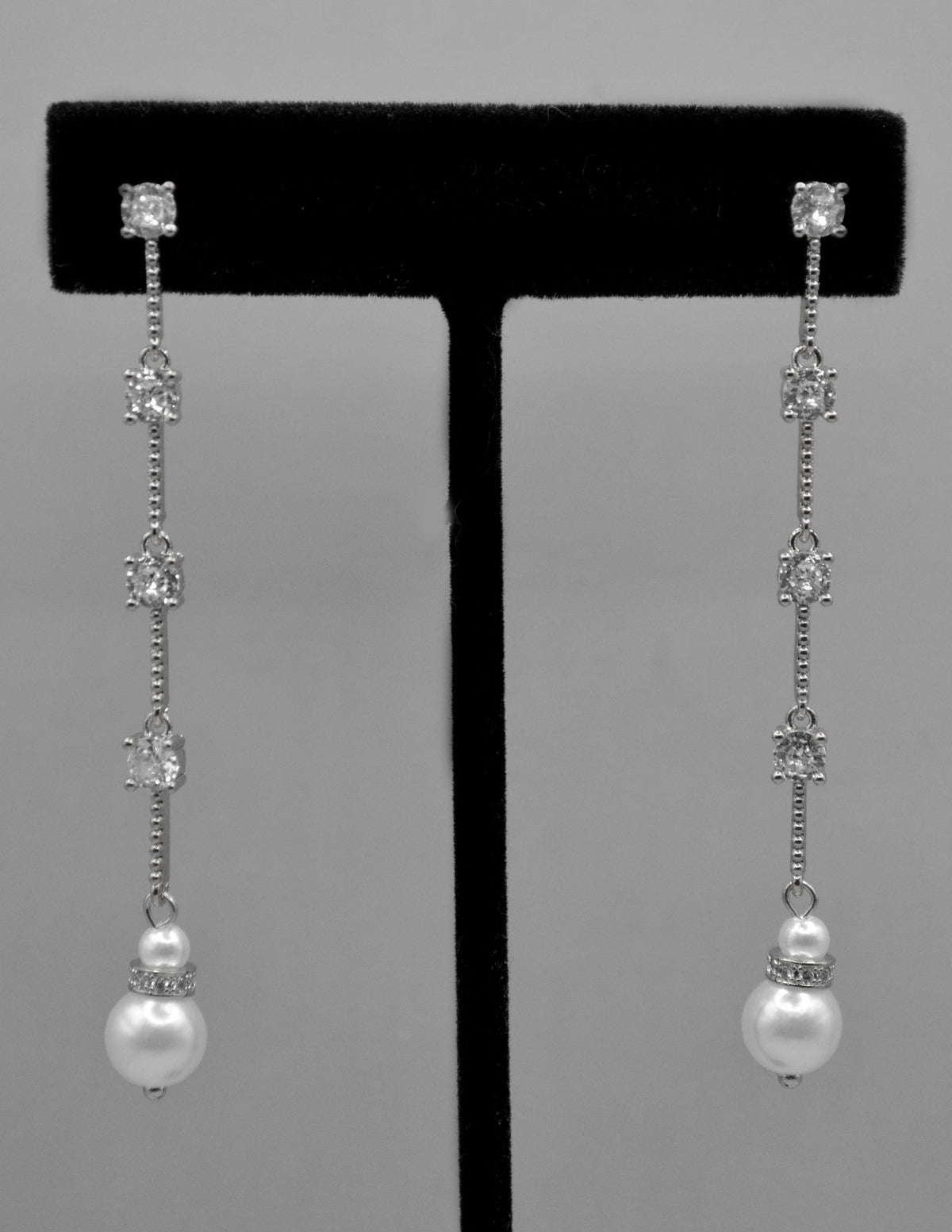 Long pearl and crystal earrings featuring fine linear drop finished with a petite pearl, detail view at Rebecca’s Louisville