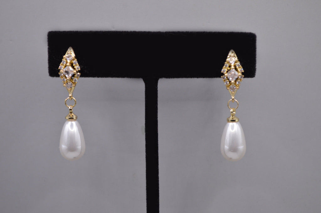 Pearl teardrop earrings featuring luminous pear-shaped pearl suspended from a petite crystal setting, product view at…