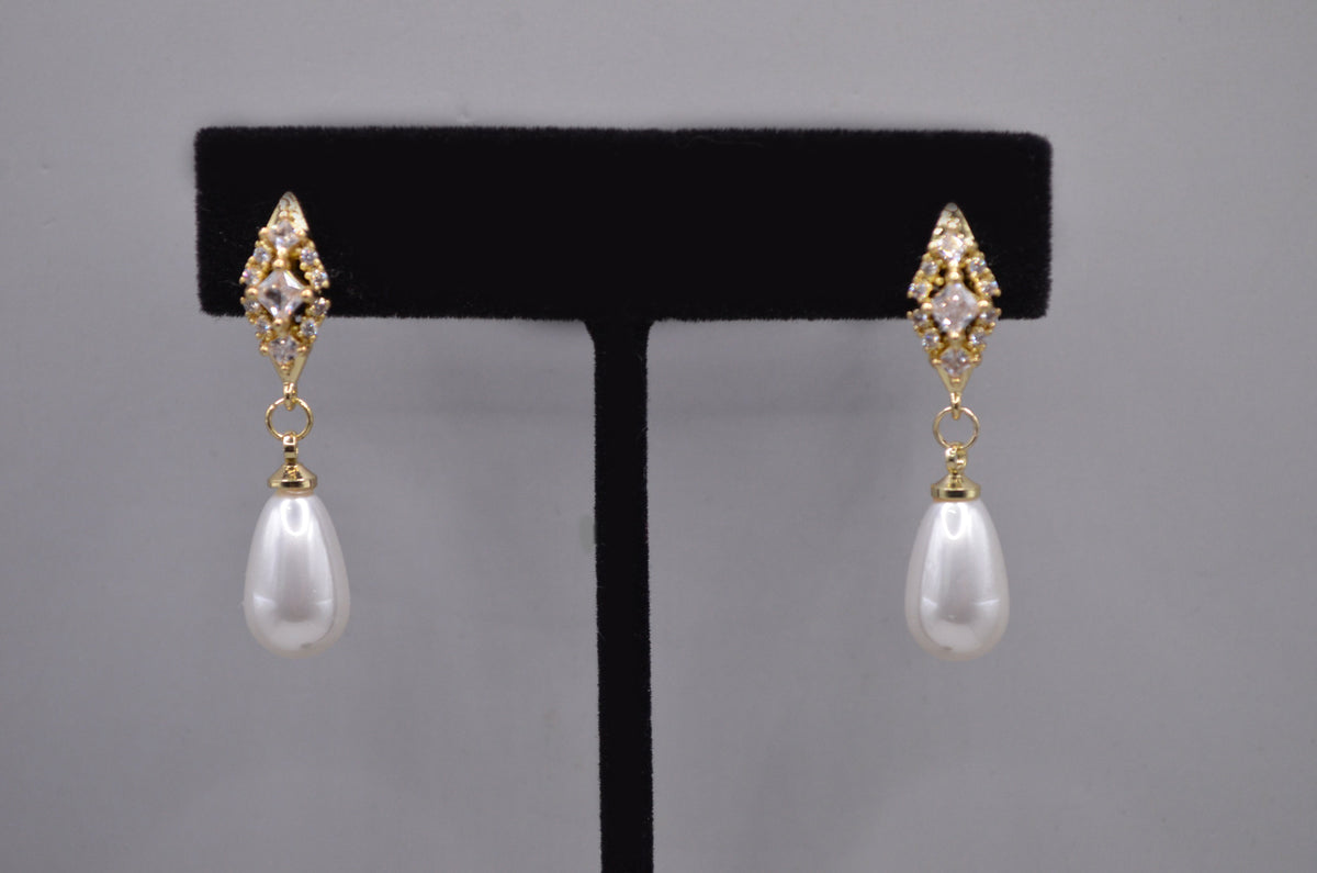 Pearl teardrop earrings featuring luminous pear-shaped pearl suspended from a petite crystal setting, product view at…