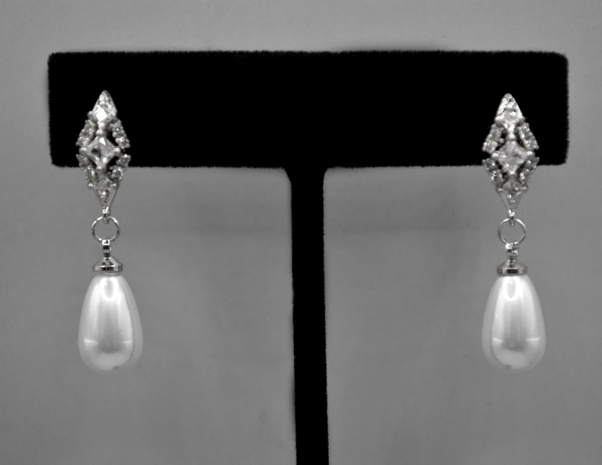 Pearl teardrop earrings featuring luminous pear-shaped pearl suspended from a petite crystal setting, alternate view at…