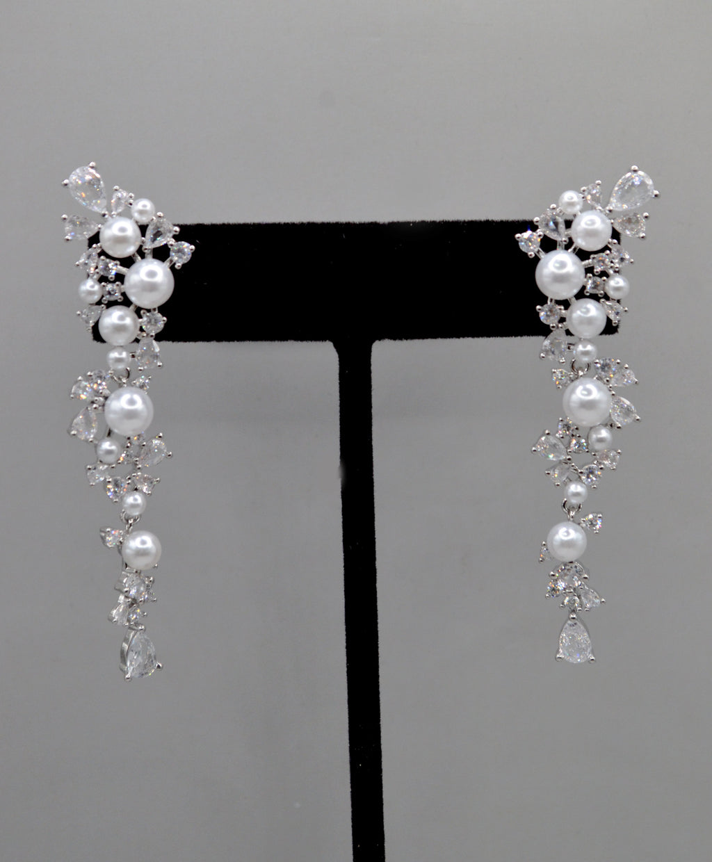 Pearl and crystal cluster earrings featuring floral cluster of pearls and clear stones in a romantic drop silhouette,…