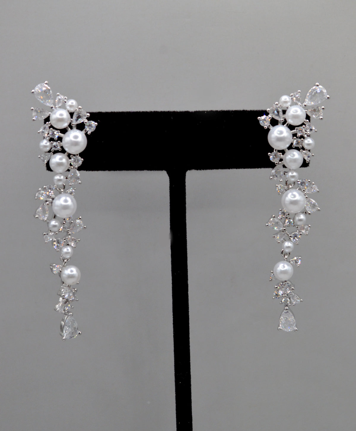 Pearl and crystal cluster earrings featuring floral cluster of pearls and clear stones in a romantic drop silhouette,…