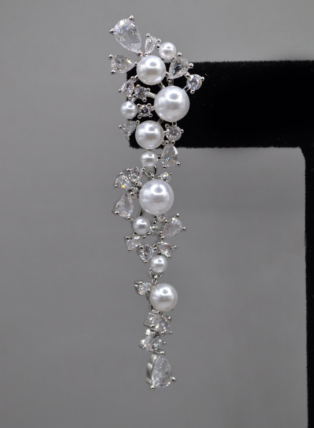 Pearl and crystal cluster earrings featuring floral cluster of pearls and clear stones in a romantic drop silhouette,…