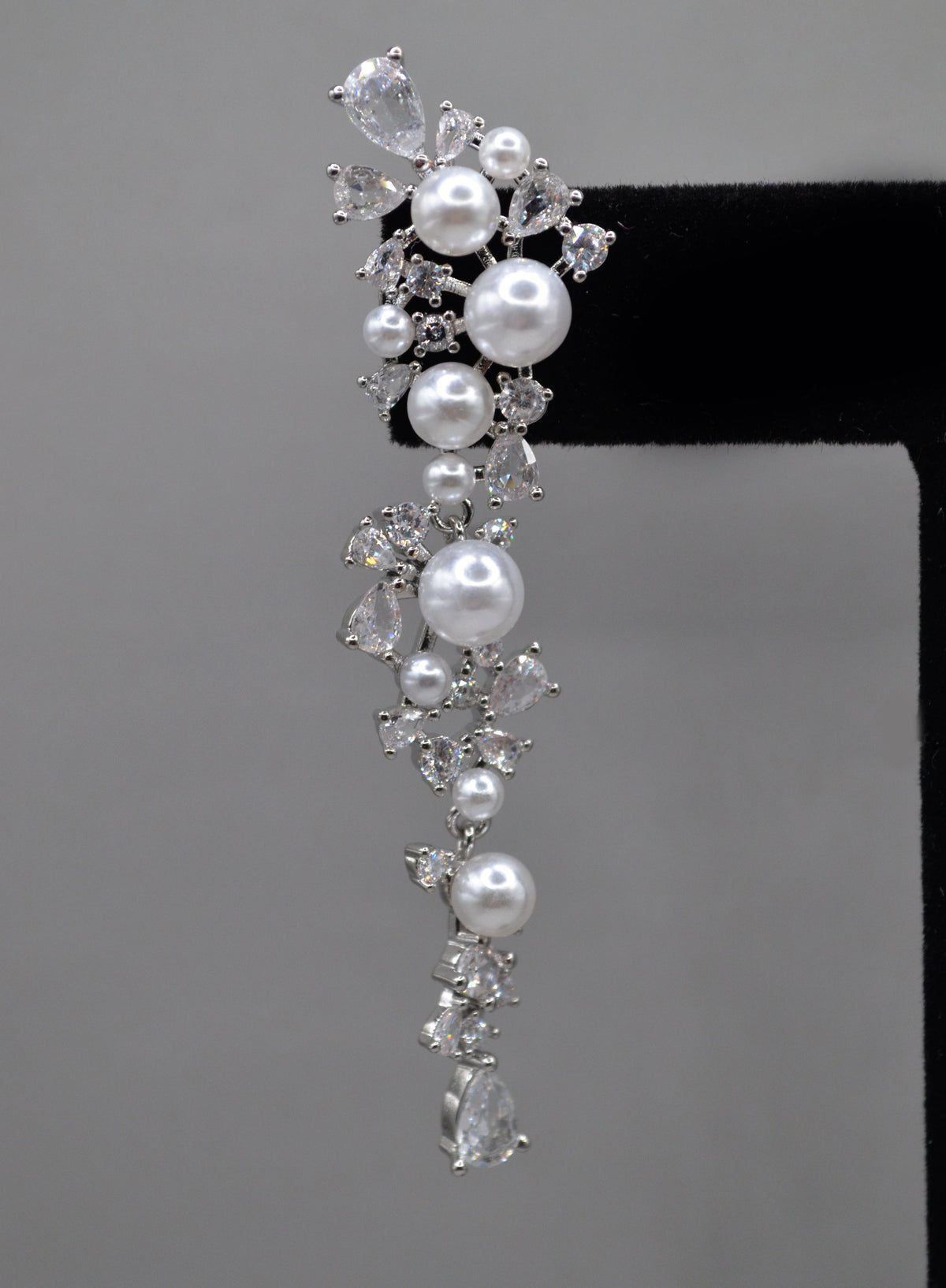 Pearl and crystal cluster earrings featuring floral cluster of pearls and clear stones in a romantic drop silhouette,…