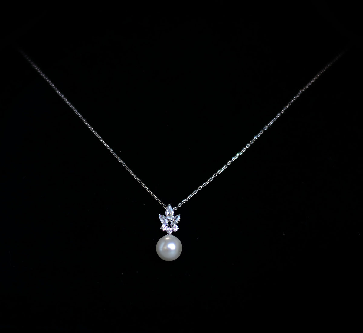 Silver-tone pearl drop pendant featuring petite crystal accent and luminous pearl drop, product view at Rebecca’s Louisville
