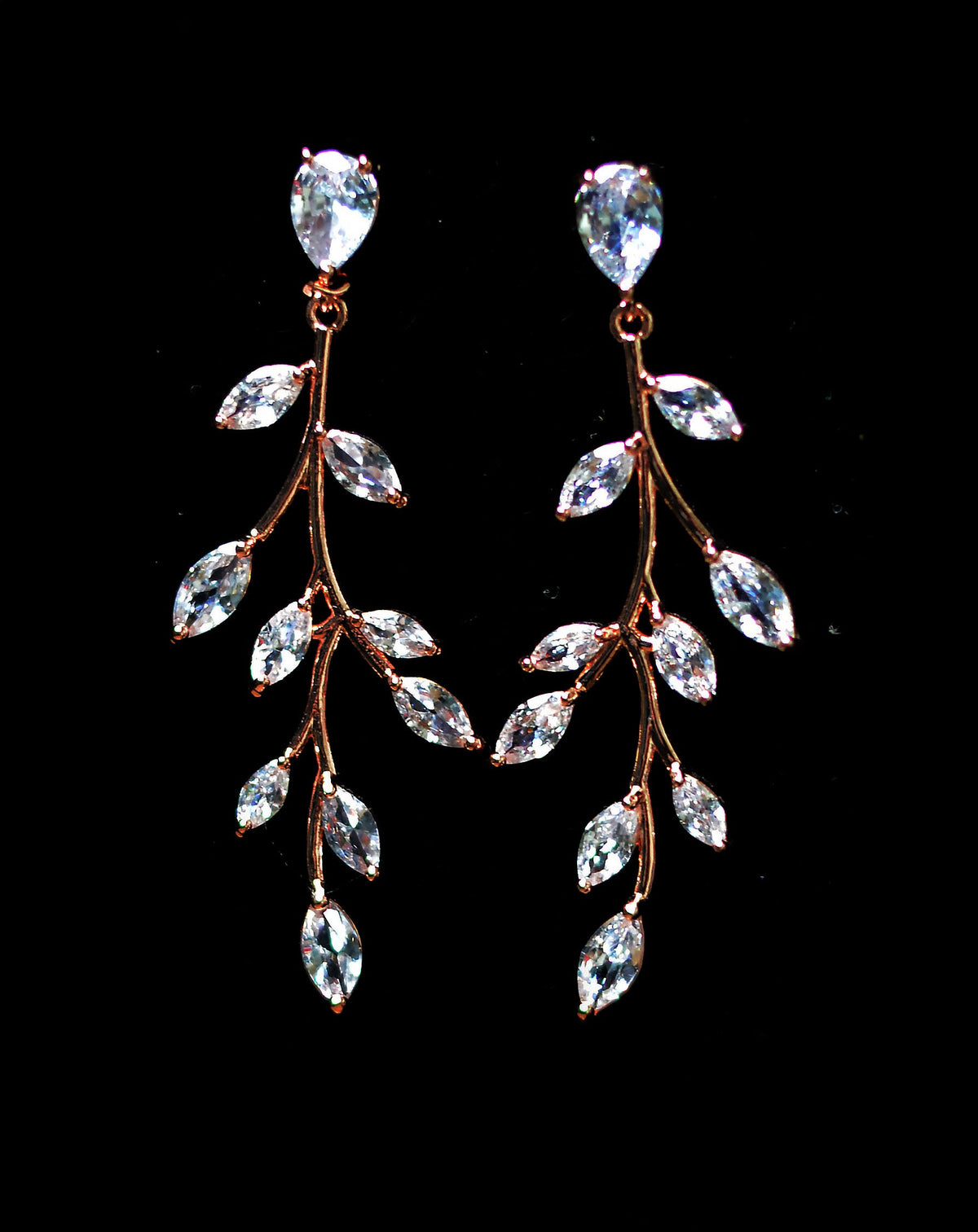 Crystal vine statement earrings featuring sweeping branch silhouette with marquise-cut leaves, product view at Rebecca’s…
