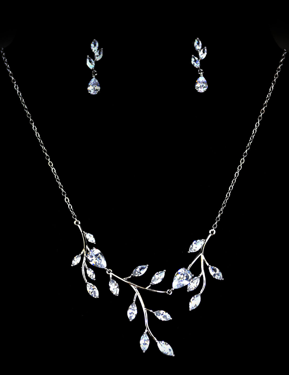 Crystal leaf necklace-and-earring set featuring branching marquise-stone design with delicate drop earrings, product view…