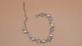 Pearl and rhinestone bracelet featuring airy vine of pearls and crystal leaves with an adjustable chain, product view at…