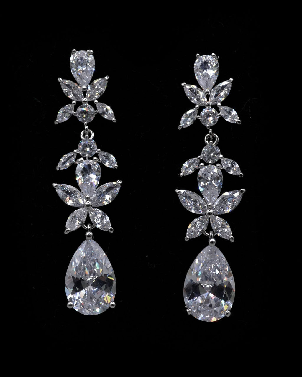 Floral crystal teardrop earrings featuring sparkling flower cluster above a brilliant pear-shaped drop, product view at…