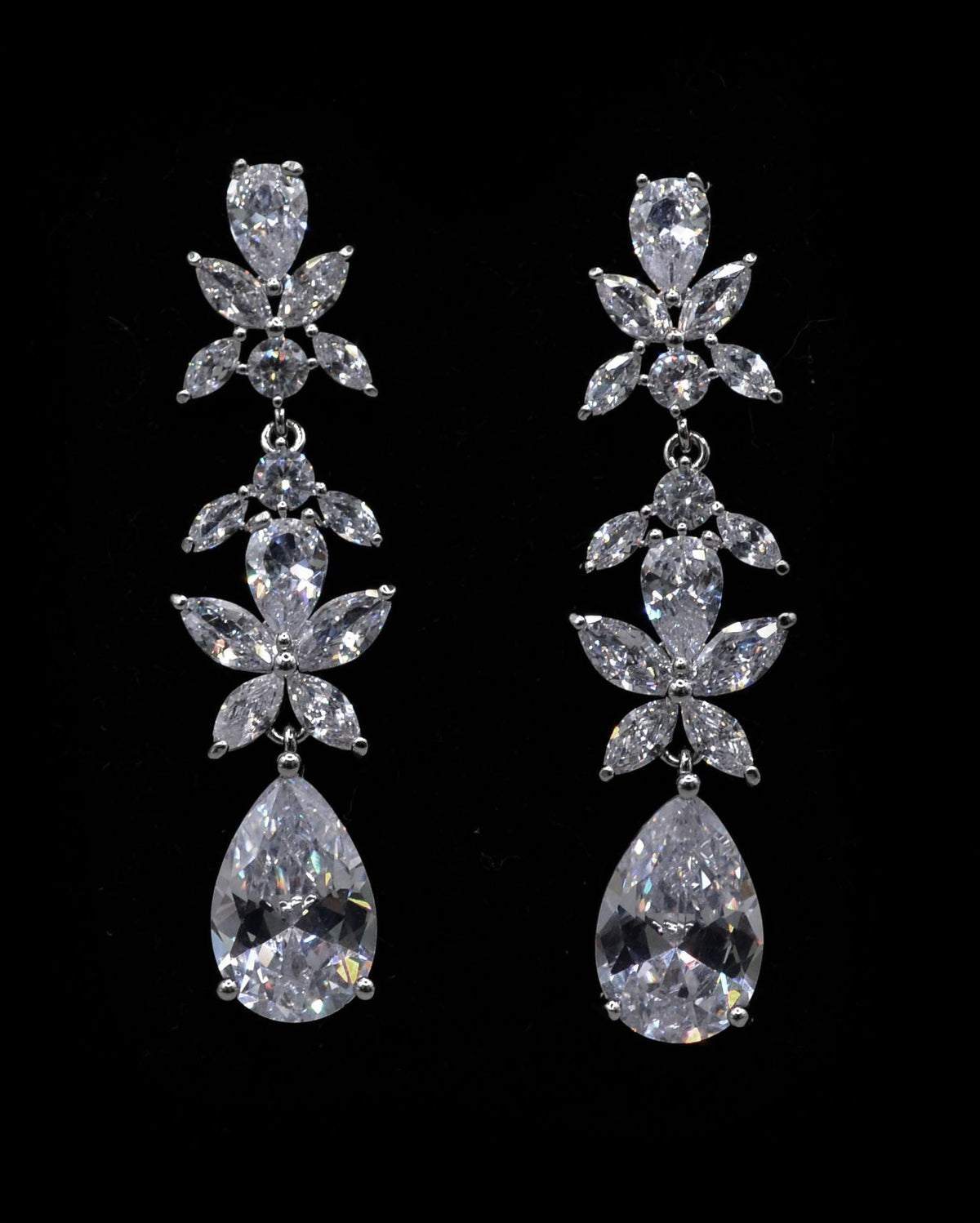 Floral crystal teardrop earrings featuring sparkling flower cluster above a brilliant pear-shaped drop, product view at…