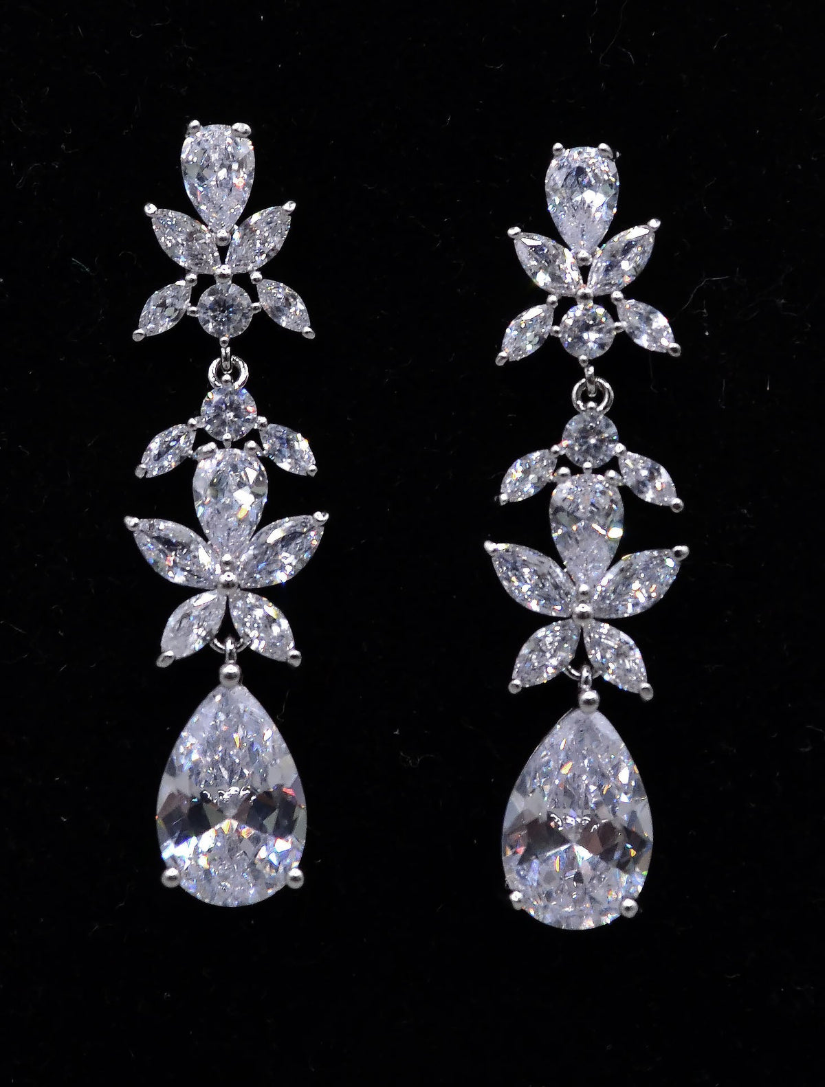Floral crystal teardrop earrings featuring sparkling flower cluster above a brilliant pear-shaped drop, alternate view at…