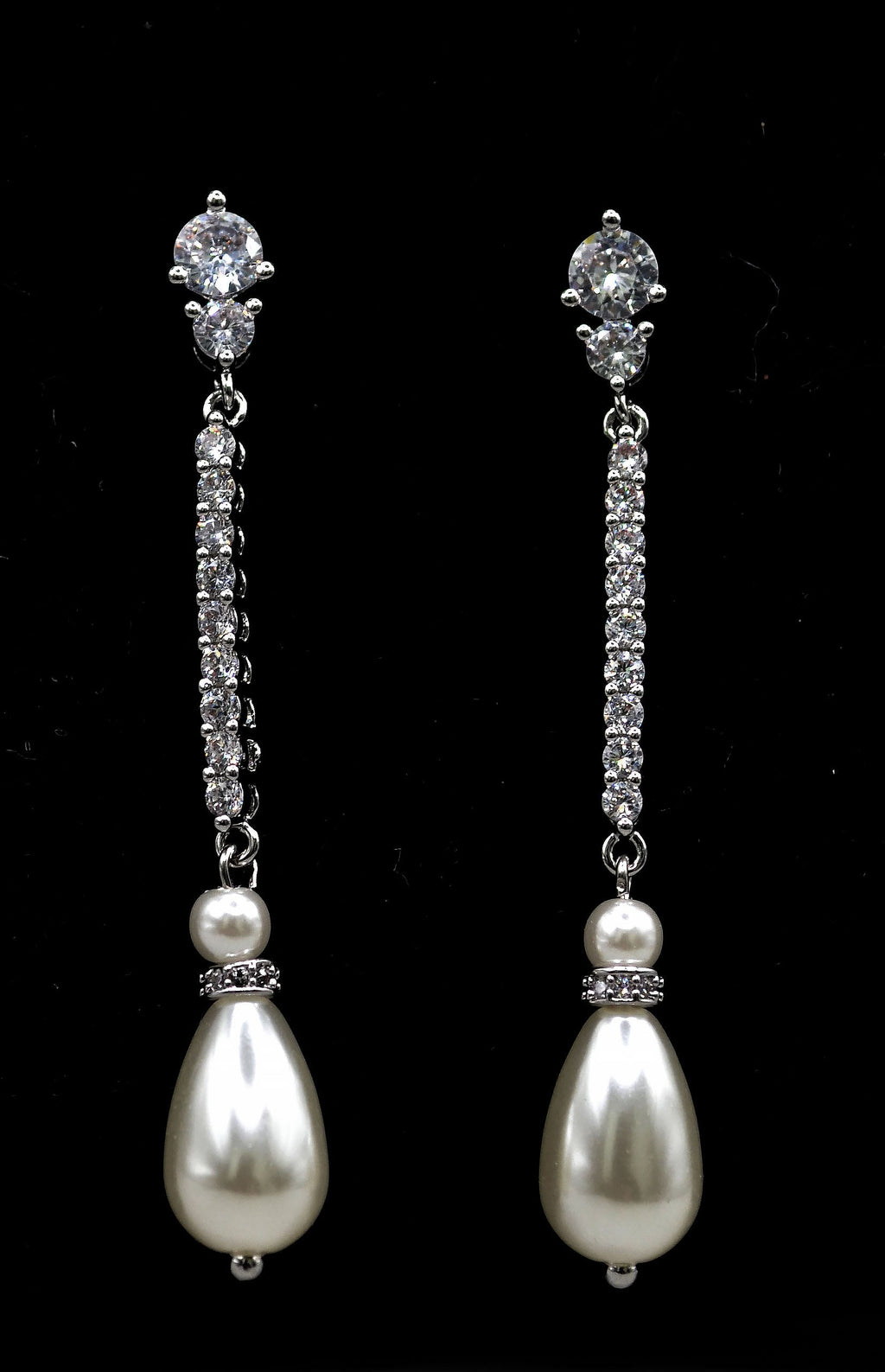 Delicate pearl drop earrings featuring fine linear crystal stem finished with a petite pearl, alternate view at Rebecca’s…