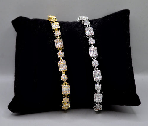 Baguette and crystal cluster bracelet featuring alternating square and round stones in a polished tennis silhouette,…