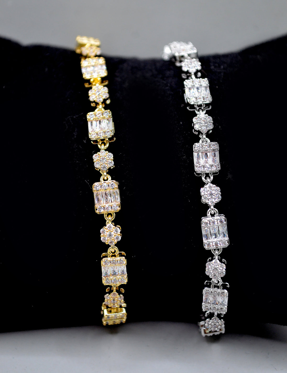 Baguette and crystal cluster bracelet featuring alternating square and round stones in a polished tennis silhouette,…