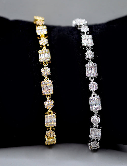 Baguette and crystal cluster bracelet featuring alternating square and round stones in a polished tennis silhouette,…