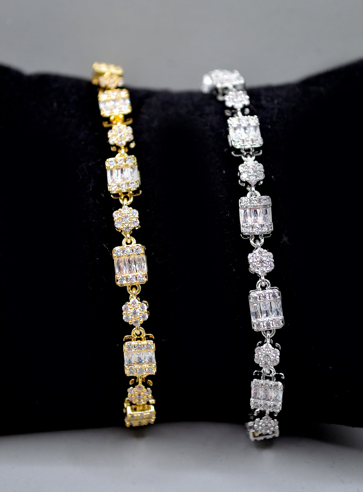 Baguette and crystal cluster bracelet featuring alternating square and round stones in a polished tennis silhouette, detail…