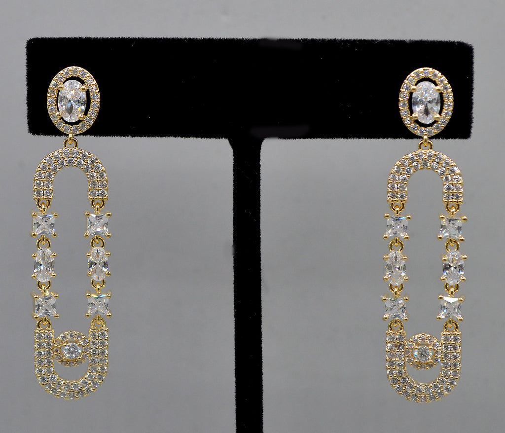 Double-loop crystal earrings featuring elongated linked loops covered in petite sparkling stones, product view at Rebecca’s…