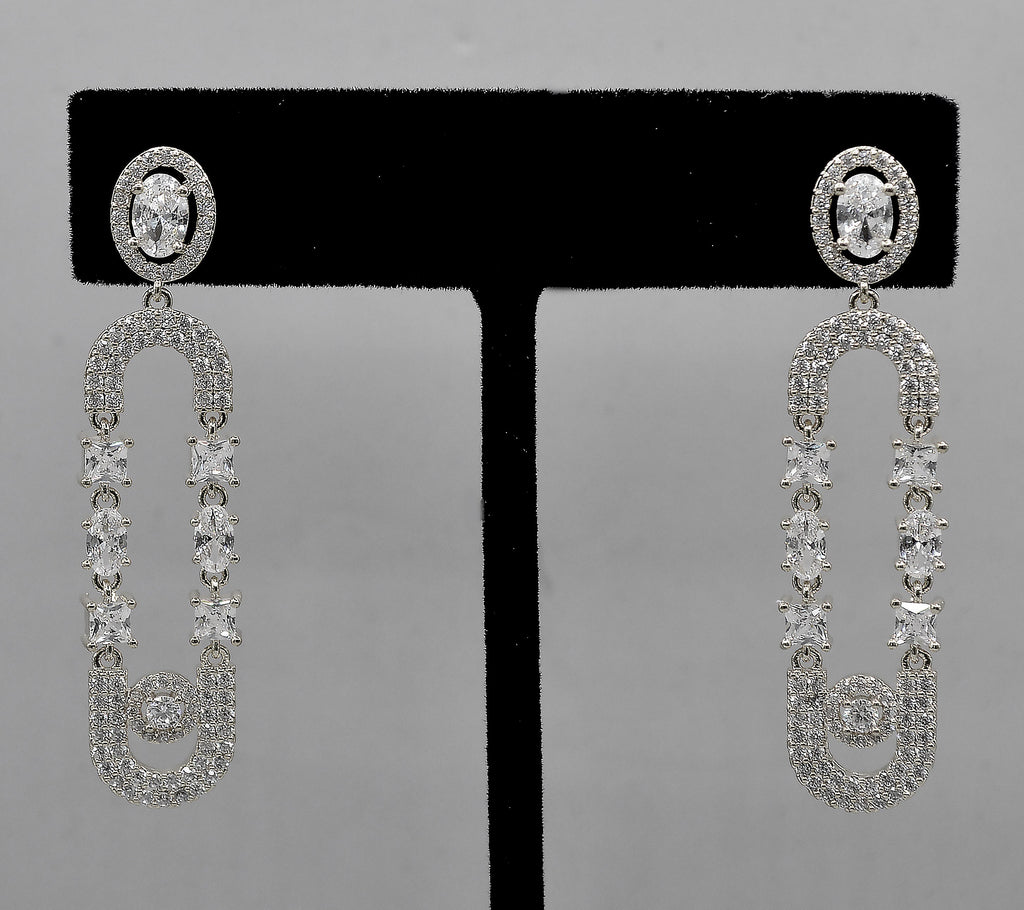 Double-loop crystal earrings featuring elongated linked loops covered in petite sparkling stones, detail view at Rebecca’s…