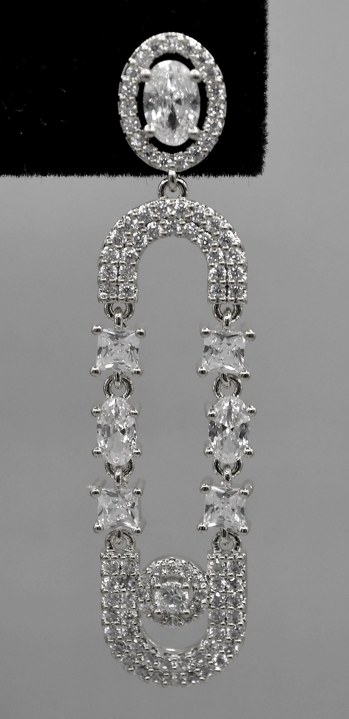 Double-loop crystal earrings featuring elongated linked loops covered in petite sparkling stones, view 4 at Rebecca’s…