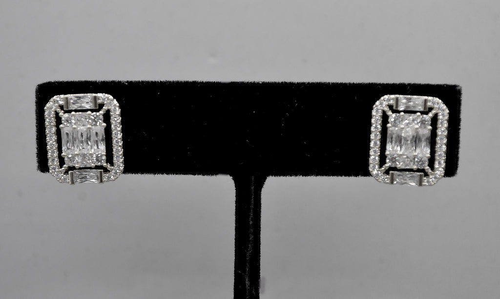 Square halo crystal studs featuring baguette-framed square center with a polished, architectural look, product view at…