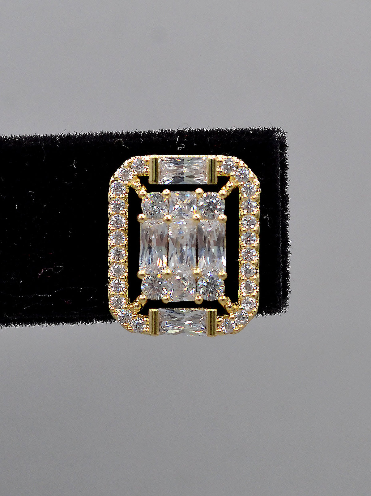 Square halo crystal studs featuring baguette-framed square center with a polished, architectural look, detail view at…