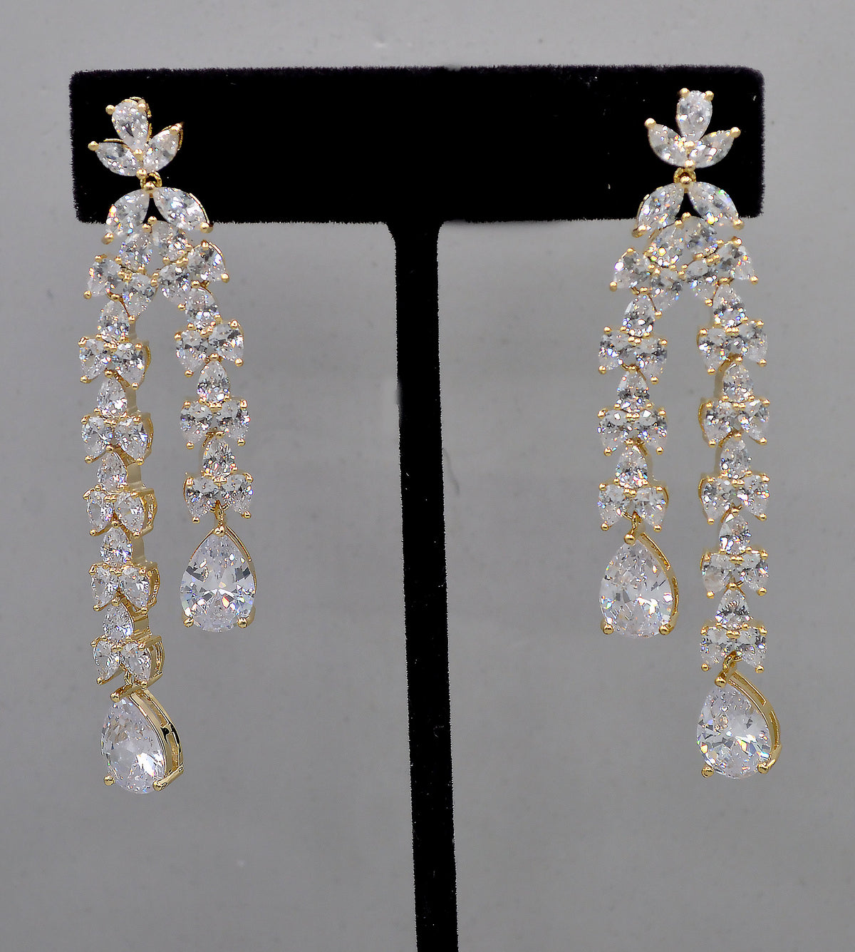 Double-drop crystal earrings featuring airy geometric chain of square and round stones, product view at Rebecca’s Louisville
