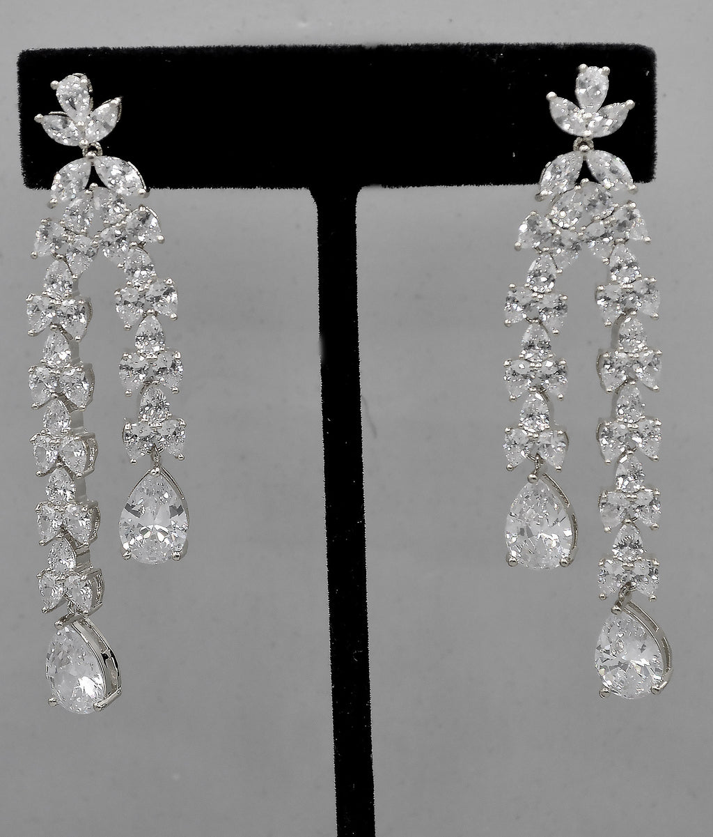 Double-drop crystal earrings featuring airy geometric chain of square and round stones, alternate view at Rebecca’s…