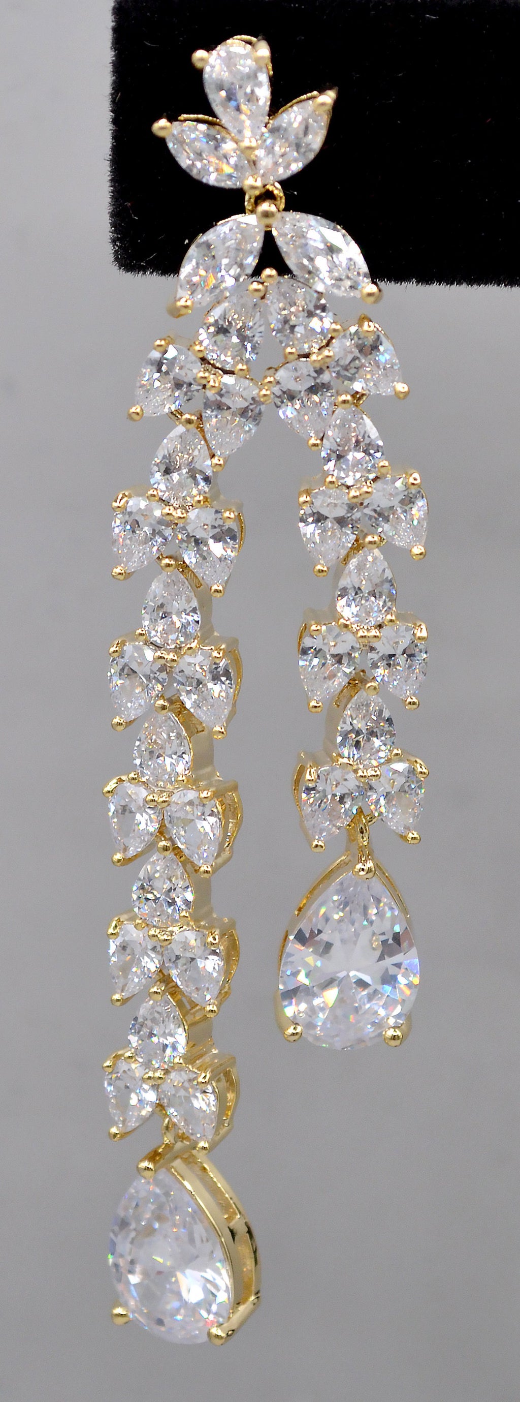 Double-drop crystal earrings featuring airy geometric chain of square and round stones, detail view at Rebecca’s Louisville