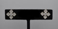 Geometric crystal clover studs featuring four square-cut stones arranged in a modern floral cross, product view at…